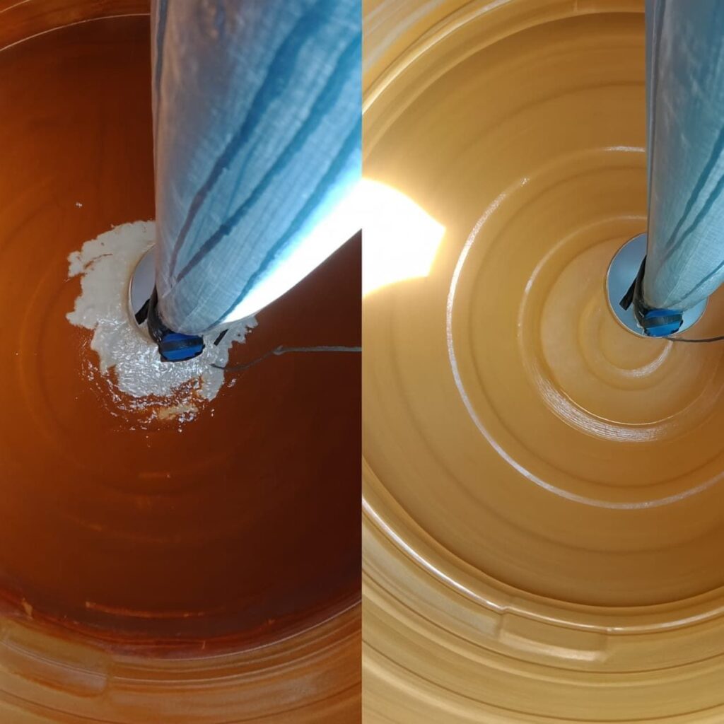 Inside view of a vertical water tank showing before and after cleaning results.