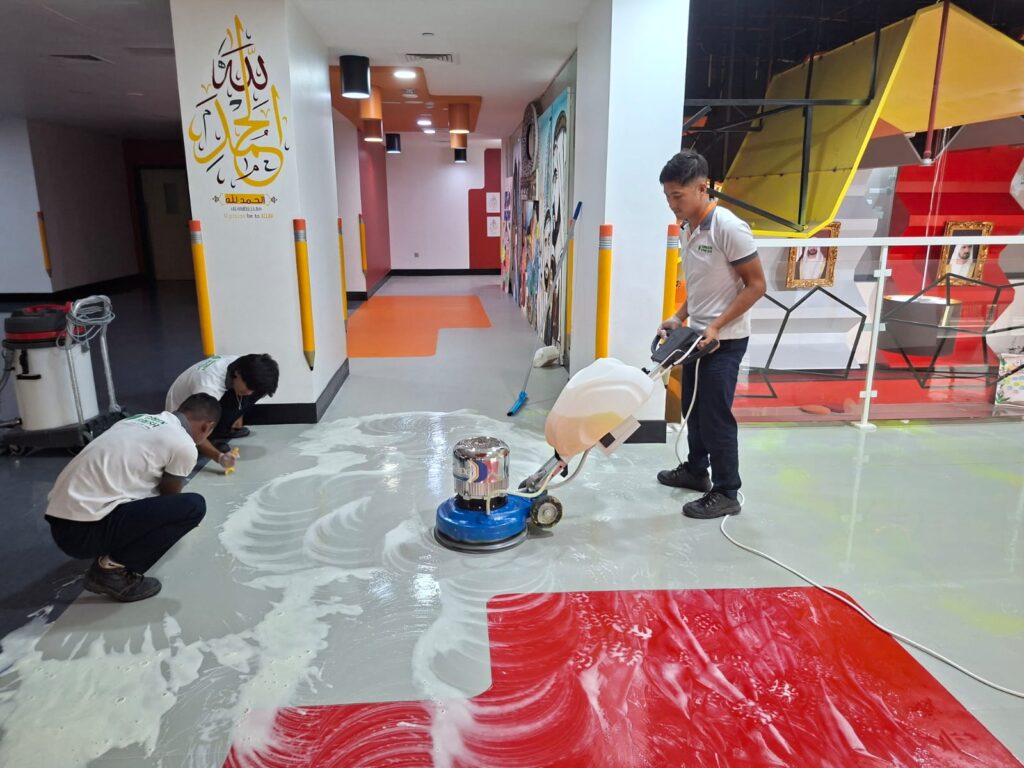 Professional cleaners performing deep cleaning services on a commercial floor in Dubai, ensuring a spotless, hygienic environment.