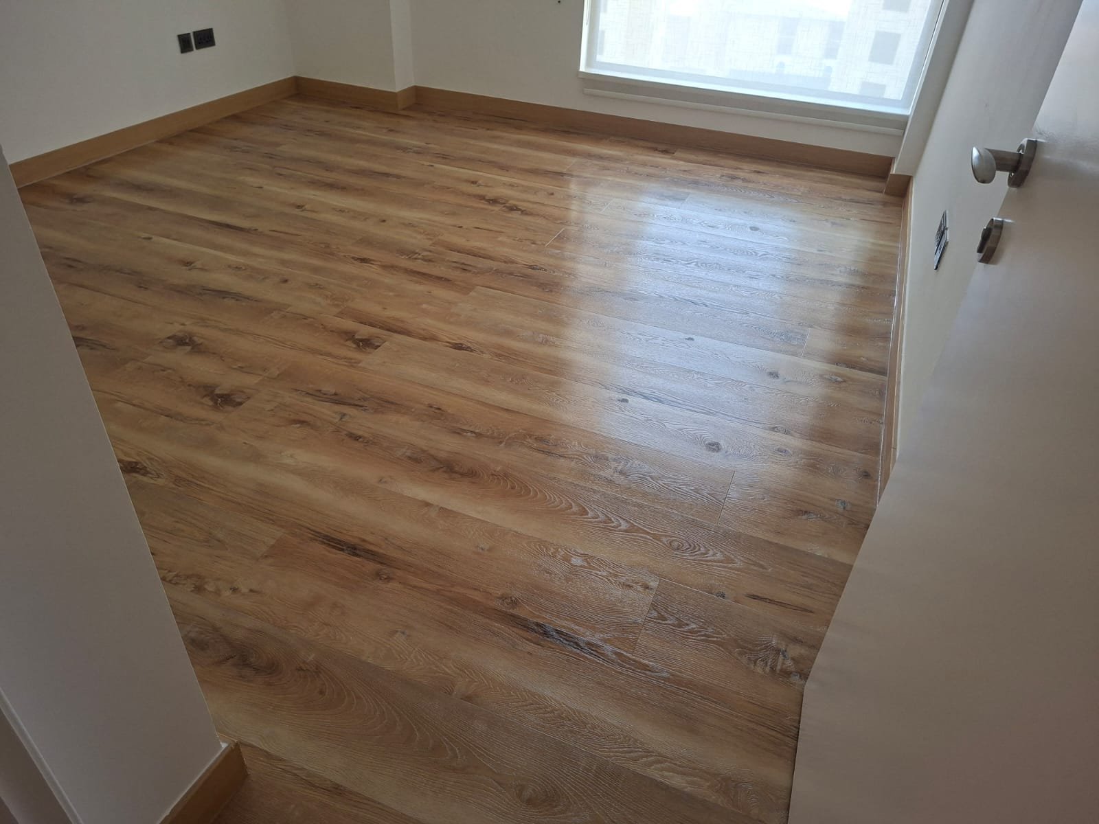 Wood-look LVT floor after deep cleaning and compatible protective treatment in JBR Dubai